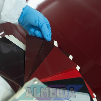 Car body shop worker chooses the right paint color before painting the vehicle