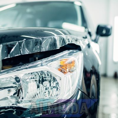 Car hood wraped in paint protection film closeup, protect against chips and scratches, nobody